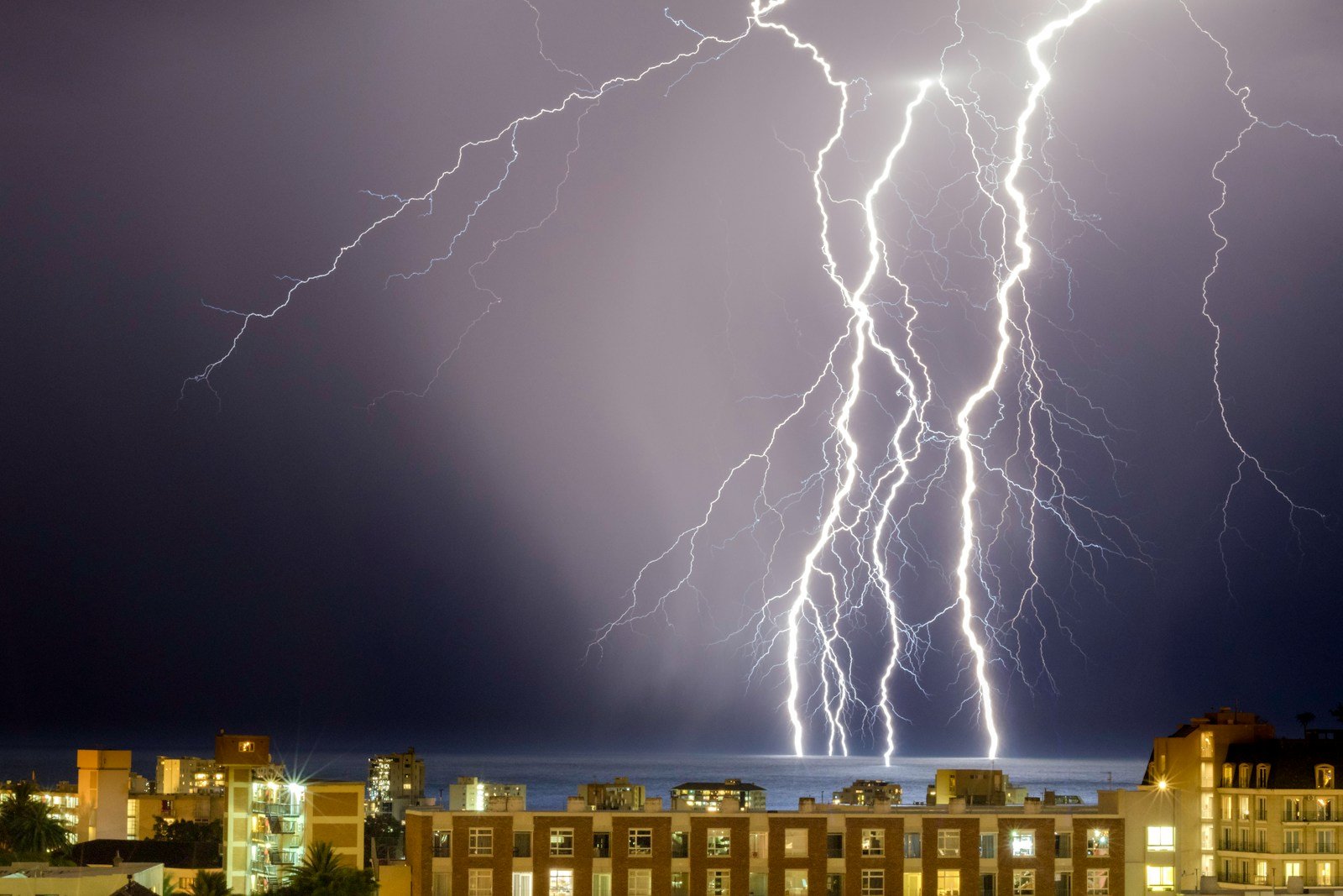 thunder on body of water near buildings